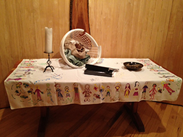 altar setup for summer 2013 - a laundry basket, some file folders, and a candle