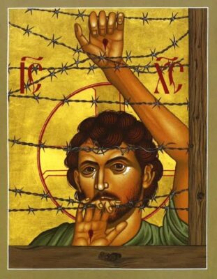 Image of Jesus behind barbed wire against golden background