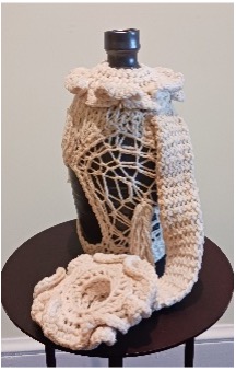 A ceramic jar encased in a fanciful crochet wrapping